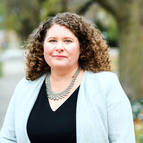 Michelle outside facing the camera in business attire
